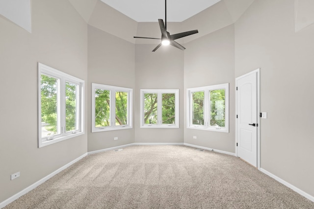 341 Tanager Dr, Woodstock, IL 60098 - spare room featuring a towering ceiling, carpet floors, and ceiling fan