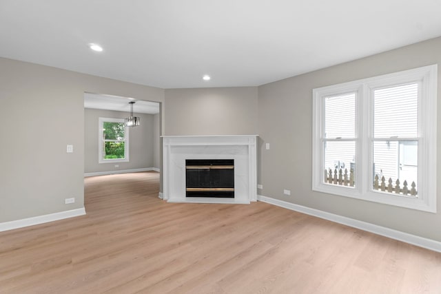 341 Tanager Dr, Woodstock, IL 60098 - unfurnished living room with light wood-style floors, a fireplace, and recessed lighting