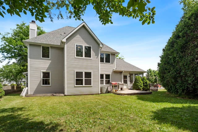 341 Tanager Dr, Woodstock, IL 60098 - back of house featuring a chimney, a shingled roof, a lawn, and a wooden deck