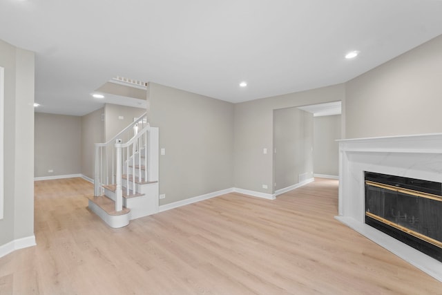 341 Tanager Dr, Woodstock, IL 60098 - unfurnished living room with wood finished floors, stairway, a high end fireplace, and recessed lighting
