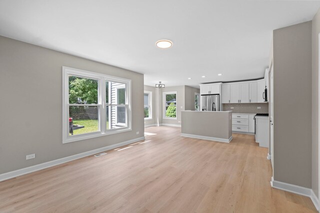 341 Tanager Dr, Woodstock, IL 60098 - unfurnished living room featuring light wood finished floors and recessed lighting