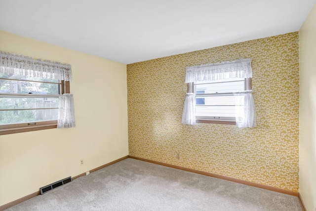 301 Virginia Dr, South Elgin, IL 60177 - carpeted empty room featuring healthy amount of natural light and wallpapered walls