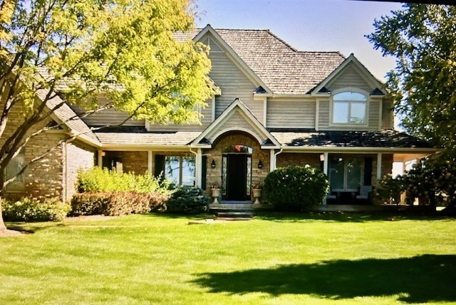 8747 Country Shire Ln, Spring Grove, IL 60081 - view of front of house with a front yard and brick siding