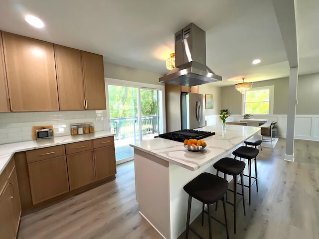 1813 218th Pl, Sauk Village, IL 60411 - kitchen featuring island range hood, freestanding refrigerator, light wood-type flooring, a kitchen bar, and recessed lighting