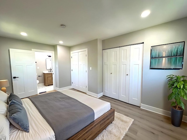 1813 218th Pl, Sauk Village, IL 60411 - bedroom with light wood-style floors, recessed lighting, connected bathroom, and multiple closets