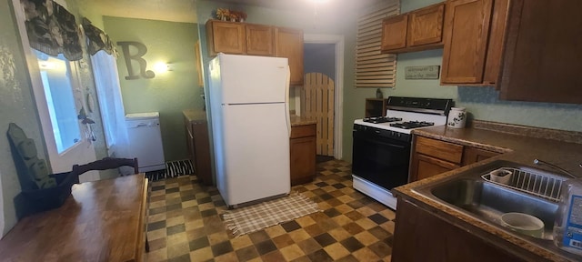 109 S 6th Ave, Sterling, IL 61081 - kitchen with white appliances, dark flooring, dark countertops, and brown cabinets