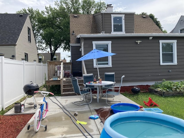 7814 S Trumbull Ave, Chicago, IL 60652 - rear view of property featuring a patio area, a chimney, outdoor dining area, a shingled roof, and a wooden deck