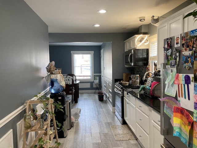 7814 S Trumbull Ave, Chicago, IL 60652 - kitchen featuring appliances with stainless steel finishes, white cabinetry, light wood-style floors, recessed lighting, and dark countertops