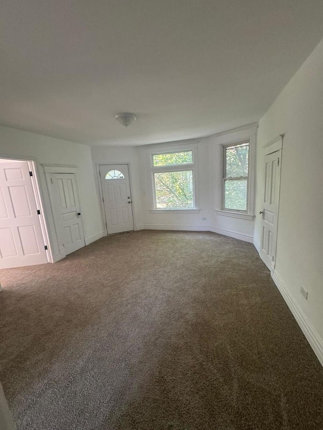 14040 Lincoln Ave, Dolton, IL 60419 - foyer entrance featuring dark colored carpet and baseboards