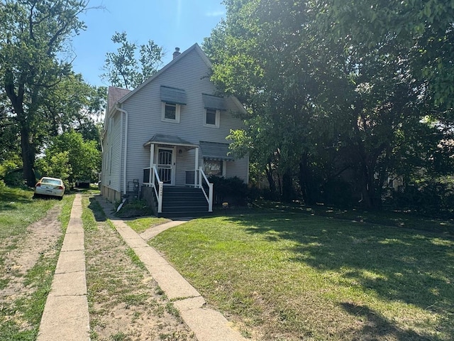 14040 Lincoln Ave, Dolton, IL 60419 - view of front facade featuring driveway, a front yard, and a chimney