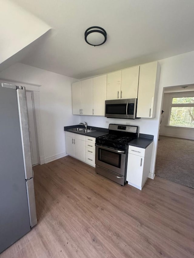 14040 Lincoln Ave, Dolton, IL 60419 - kitchen with appliances with stainless steel finishes, dark countertops, and light wood-style floors