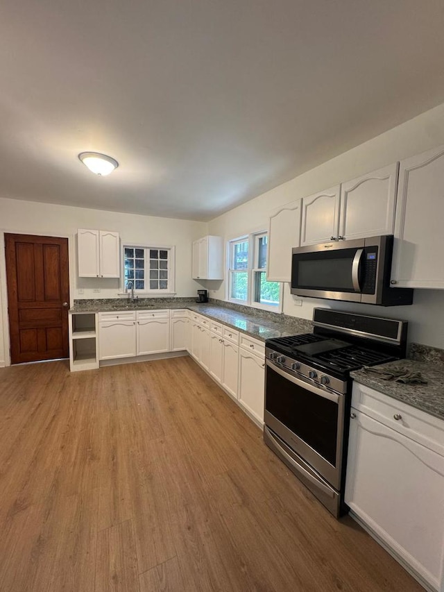 14040 Lincoln Ave, Dolton, IL 60419 - kitchen with stainless steel appliances, light wood-style floors, white cabinets, and dark countertops