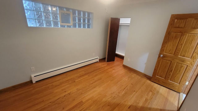 5448 W Agatite Ave, Chicago, IL 60630 - unfurnished bedroom featuring a baseboard radiator and light wood finished floors