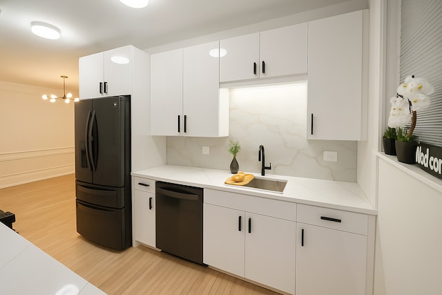 230 N Oak Park Ave Unit 1K, Oak Park, IL 60302 - kitchen with dishwasher, black fridge with ice dispenser, light wood-type flooring, a chandelier, and light countertops