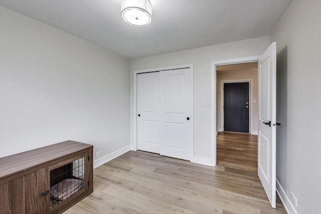 1333 W Touhy Ave Unit 102, Park Ridge, IL 60068 - unfurnished bedroom featuring light wood-type flooring and a closet
