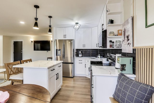 1333 W Touhy Ave Unit 102, Park Ridge, IL 60068 - kitchen with stainless steel appliances, open shelves, light wood finished floors, and white cabinetry