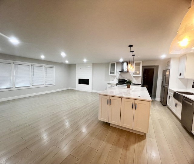 225 Webster Ln, Schaumburg, IL 60193 - kitchen featuring wall chimney range hood, stainless steel appliances, a kitchen island, recessed lighting, and light wood-type flooring