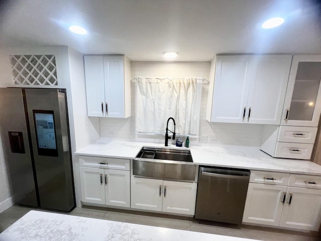 225 Webster Ln, Schaumburg, IL 60193 - kitchen with appliances with stainless steel finishes, white cabinetry, light stone counters, decorative backsplash, and glass insert cabinets