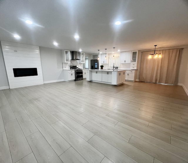 225 Webster Ln, Schaumburg, IL 60193 - unfurnished living room featuring light wood-style floors, a fireplace, and recessed lighting