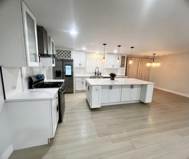 225 Webster Ln, Schaumburg, IL 60193 - kitchen with appliances with stainless steel finishes, wall chimney range hood, a kitchen island, white cabinets, and glass insert cabinets
