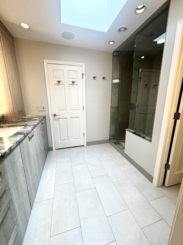 4049 Michelline Ln, Northbrook, IL 60062 - bathroom featuring a skylight, a stall shower, tile patterned flooring, double vanity, and recessed lighting
