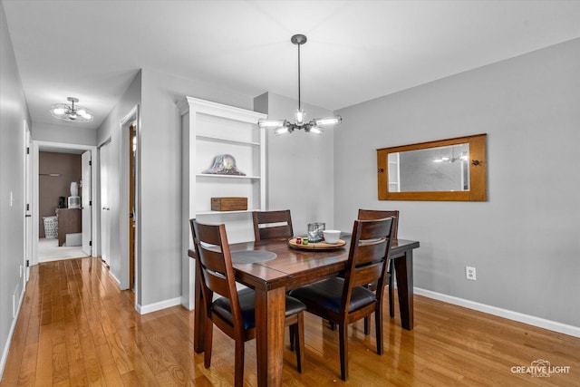 906 Whitetail Ln, Sandwich, IL 60548 - dining area featuring a chandelier and light wood-style flooring