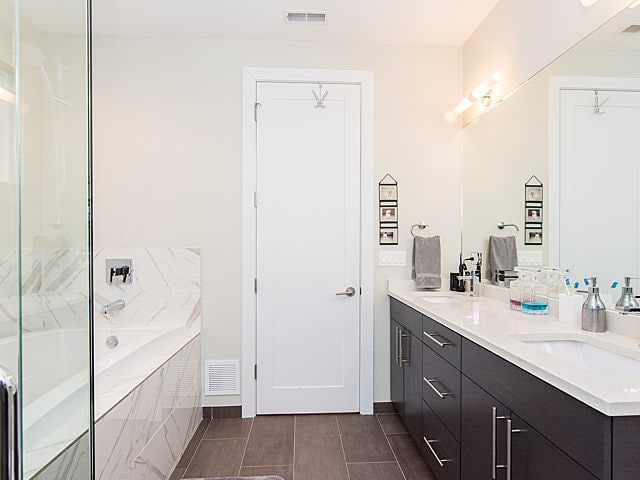 2036 W Huron St, Chicago, IL 60612 - full bathroom featuring double vanity, a garden tub, and a shower