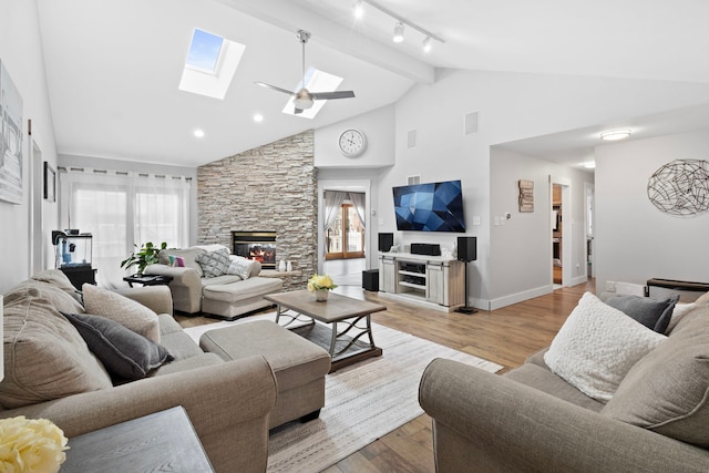 18049 Brittany Ln, Lansing, IL 60438 - living room featuring a skylight, a fireplace, light wood finished floors, high vaulted ceiling, and track lighting