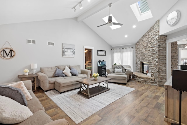 18049 Brittany Ln, Lansing, IL 60438 - living area with high vaulted ceiling, a stone fireplace, beam ceiling, hardwood / wood-style floors, and a ceiling fan
