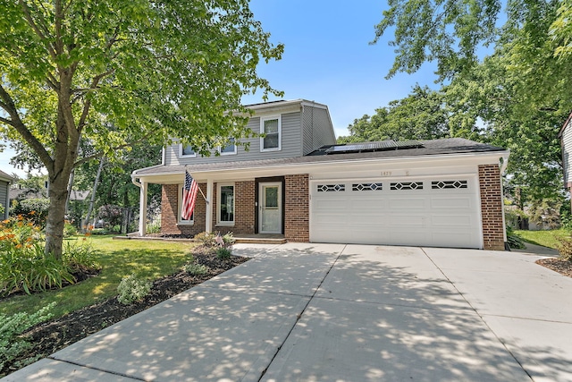 1479 Exeter Ct, Hoffman Estates, IL 60010 - traditional home with brick siding, solar panels, concrete driveway, an attached garage, and a front lawn