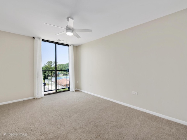 123 Acacia Cir Unit 414, Indian Head Park, IL 60525 - spare room featuring a ceiling fan, light colored carpet, and a wall of windows