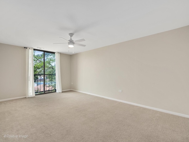 123 Acacia Cir Unit 414, Indian Head Park, IL 60525 - unfurnished room featuring ceiling fan, light colored carpet, and a wall of windows