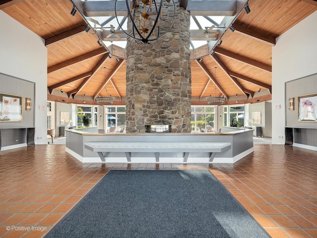 123 Acacia Cir Unit 414, Indian Head Park, IL 60525 - unfurnished living room with high vaulted ceiling, a wooden ceiling with exposed beams, and tile patterned floors