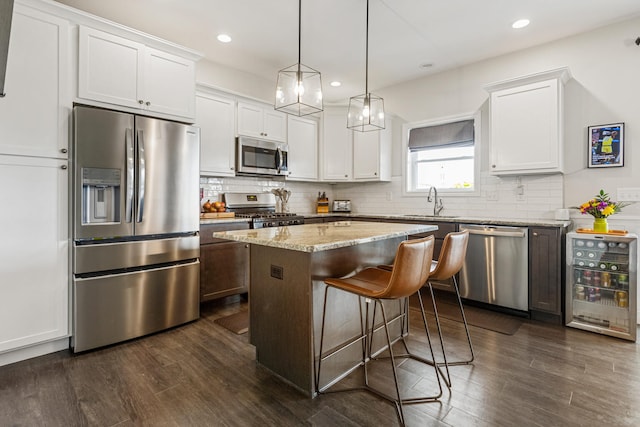 806 Cole Ln, Mahomet, IL 61853 - kitchen with appliances with stainless steel finishes, dark wood finished floors, white cabinetry, and recessed lighting