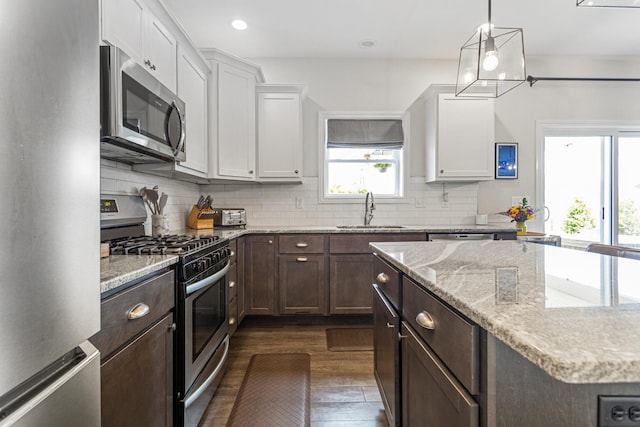 806 Cole Ln, Mahomet, IL 61853 - kitchen with appliances with stainless steel finishes, white cabinets, dark brown cabinets, tasteful backsplash, and recessed lighting