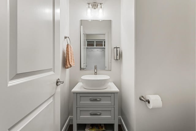 806 Cole Ln, Mahomet, IL 61853 - half bathroom featuring vanity and baseboards