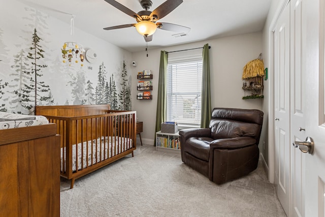 806 Cole Ln, Mahomet, IL 61853 - bedroom featuring light carpet, a crib, and ceiling fan