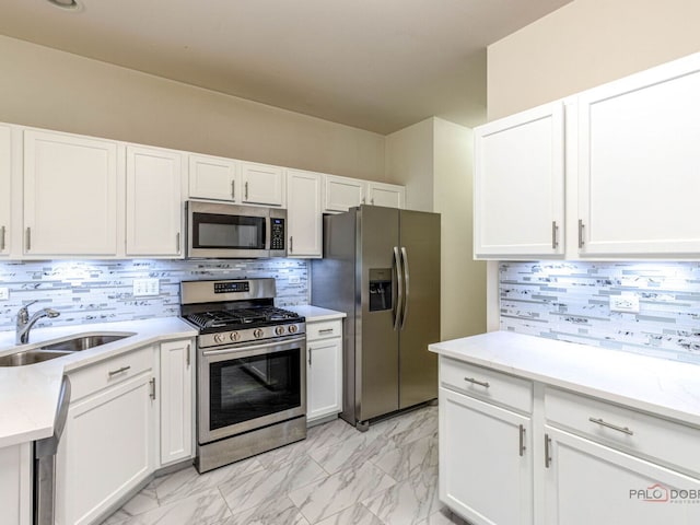 696 S Jade Ln, Round Lake, IL 60073 - kitchen featuring appliances with stainless steel finishes, light marble finish floors, decorative backsplash, and white cabinets