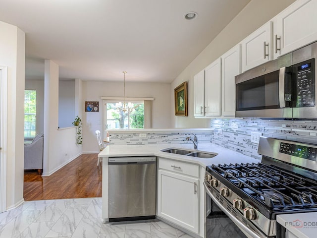 696 S Jade Ln, Round Lake, IL 60073 - kitchen featuring stainless steel appliances, a peninsula, light marble finish floors, white cabinets, and recessed lighting