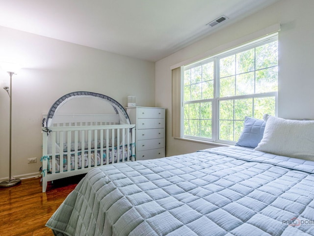 696 S Jade Ln, Round Lake, IL 60073 - bedroom with multiple windows and wood finished floors