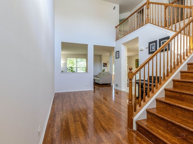 696 S Jade Ln, Round Lake, IL 60073 - foyer entrance with hardwood / wood-style flooring, stairway, and a high ceiling