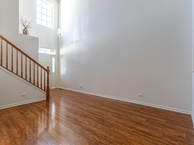 696 S Jade Ln, Round Lake, IL 60073 - unfurnished living room featuring wood finished floors and stairway