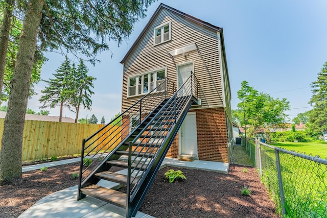 4438 S Knox Ave, Chicago, IL 60632 - view of front of house with stairway, a fenced backyard, and brick siding
