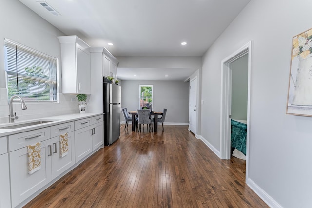 4438 S Knox Ave, Chicago, IL 60632 - kitchen featuring freestanding refrigerator, dark wood finished floors, light countertops, white cabinetry, and tasteful backsplash