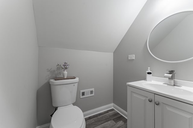 4438 S Knox Ave, Chicago, IL 60632 - bathroom featuring vanity, wood finished floors, and vaulted ceiling