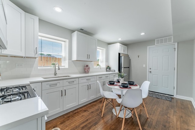 4438 S Knox Ave, Chicago, IL 60632 - kitchen featuring freestanding refrigerator, dark wood finished floors, decorative backsplash, white cabinets, and recessed lighting