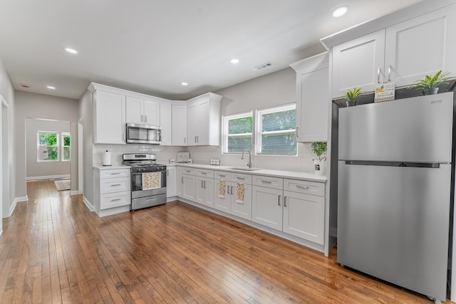 4438 S Knox Ave, Chicago, IL 60632 - kitchen featuring appliances with stainless steel finishes, light countertops, tasteful backsplash, and recessed lighting