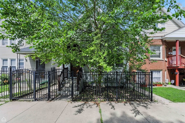 2314 N Mango Ave, Chicago, IL 60639 - view of front facade with a fenced front yard, a gate, and brick siding