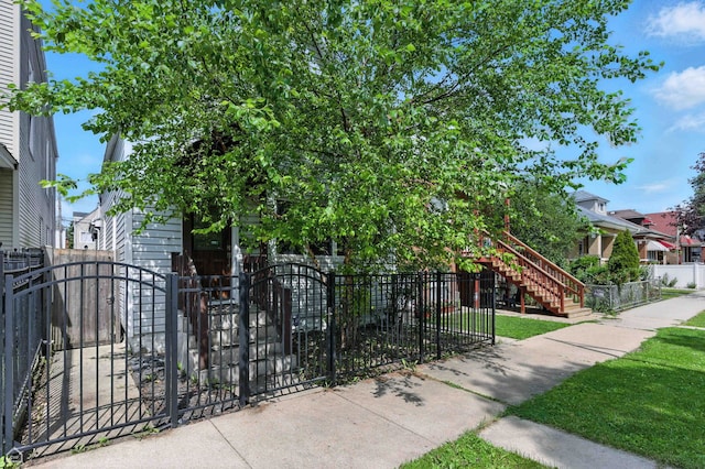 2314 N Mango Ave, Chicago, IL 60639 - view of property's community featuring a fenced front yard, a gate, stairway, and a residential view