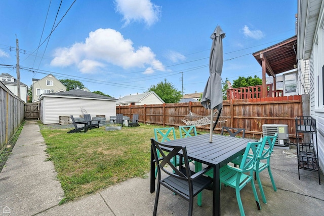 2314 N Mango Ave, Chicago, IL 60639 - fenced backyard with a patio, outdoor dining space, and an outdoor structure